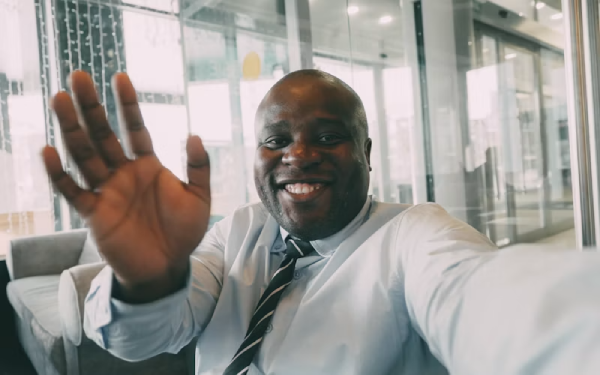 A male worker waving on a live meeting